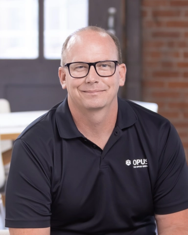 portrait of a smiling person in a collared shirt